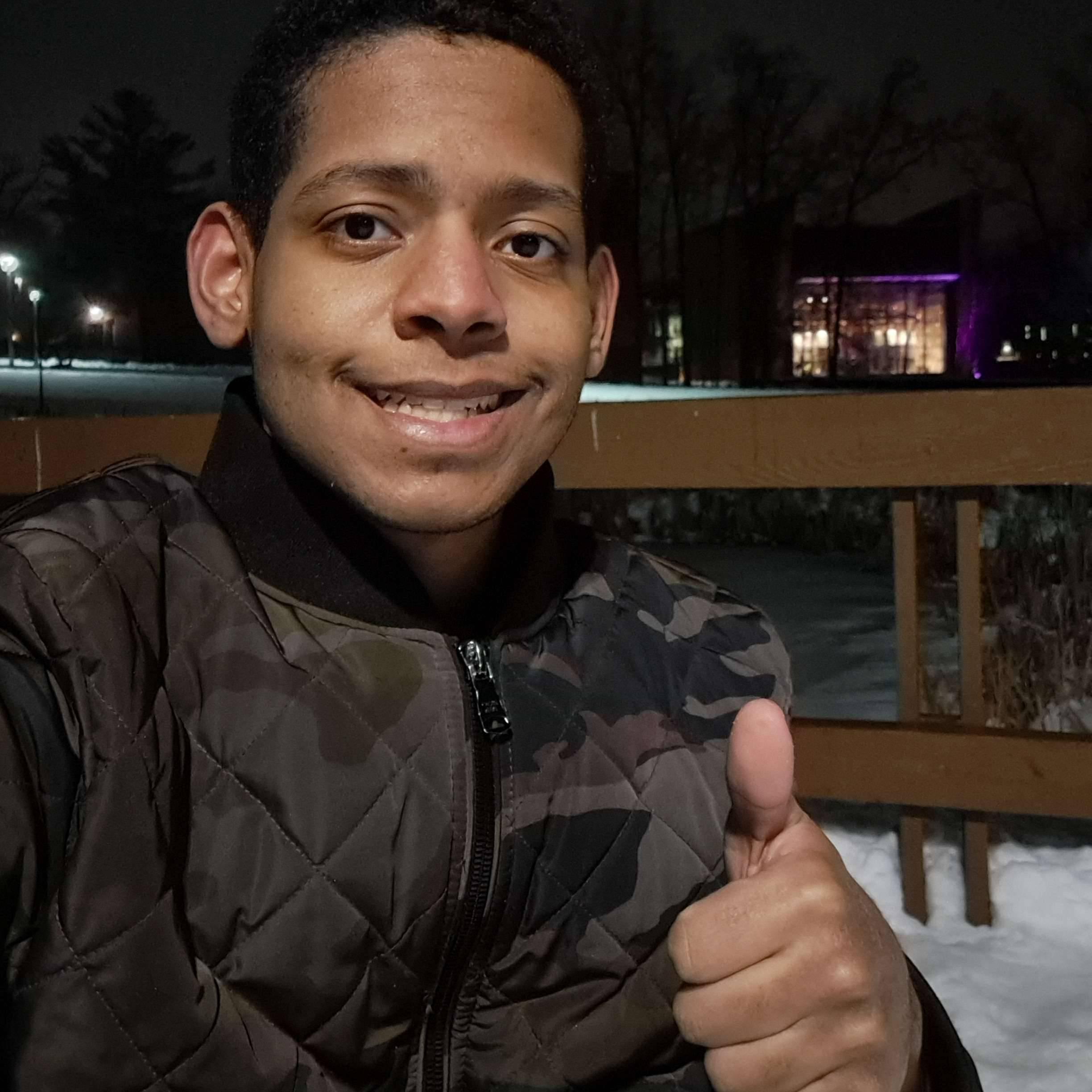 Randy taking a selfie outside, giving a thumbs up